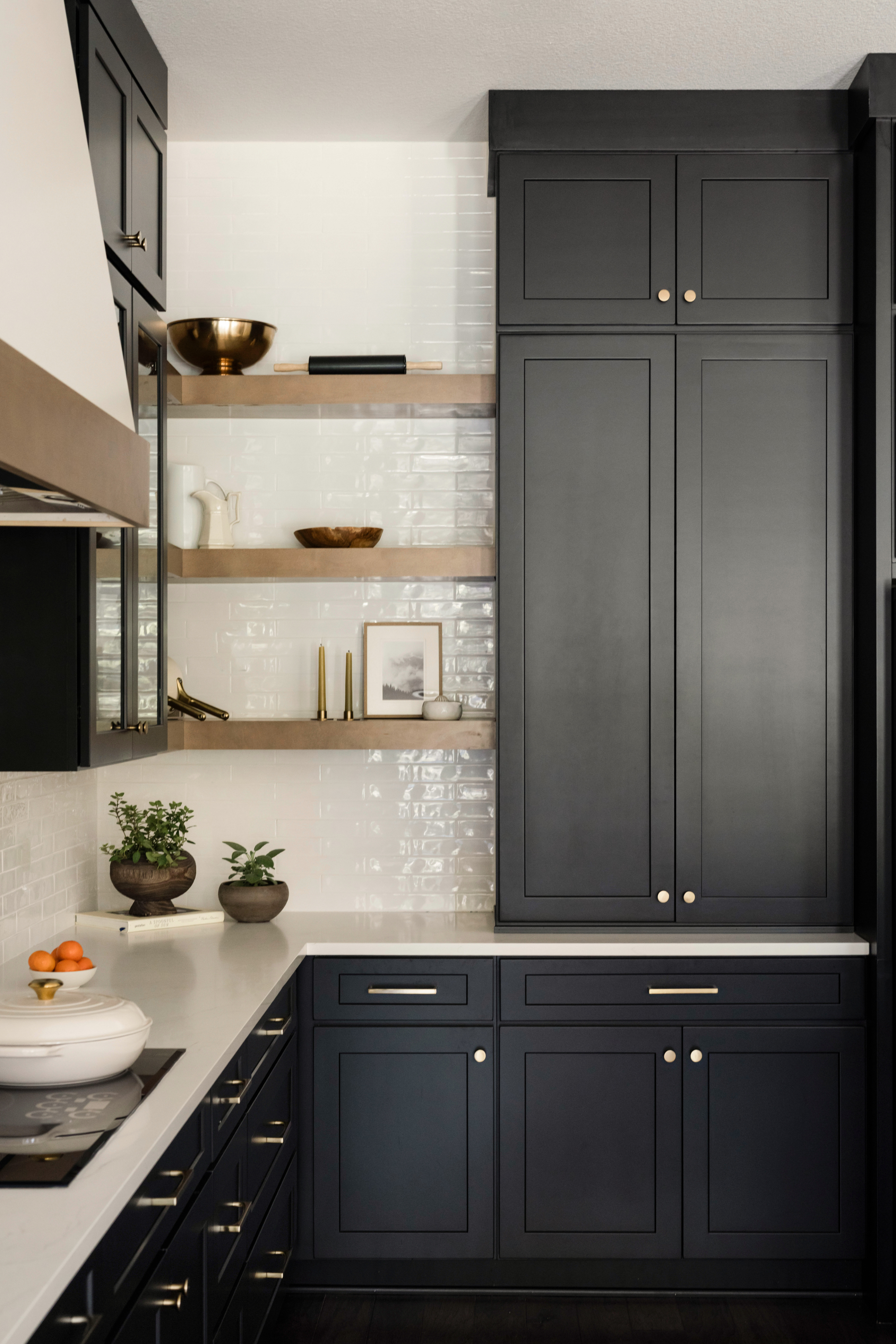Navy painted shaker stock cabinets with brass hardware
