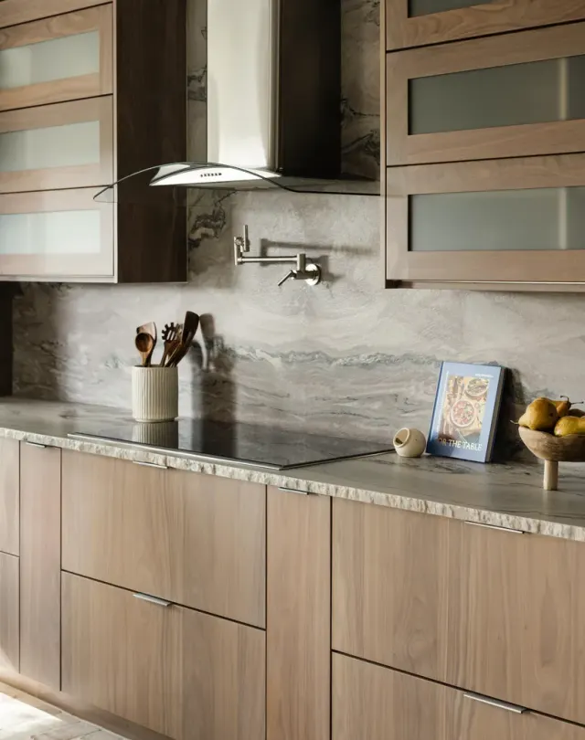 Burnside Circle Residence: Walnut flat-panel from Bellmont's semi-custom line, frameless construction, integrated refrigerator panels, frosted-glass uppers, deep drawer banks, pot filler — view 2