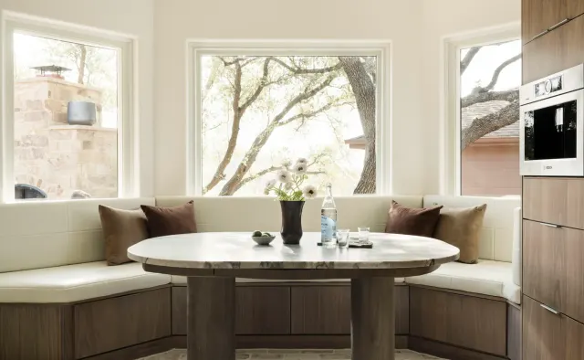 Burnside Circle Residence: Walnut flat-panel from Bellmont's semi-custom line, frameless construction, integrated refrigerator panels, frosted-glass uppers, deep drawer banks, pot filler — view 4