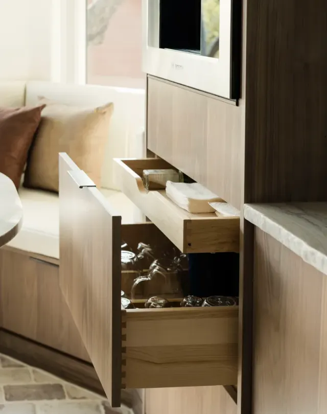 Burnside Circle Residence: Walnut flat-panel from Bellmont's semi-custom line, frameless construction, integrated refrigerator panels, frosted-glass uppers, deep drawer banks, pot filler — view 5
