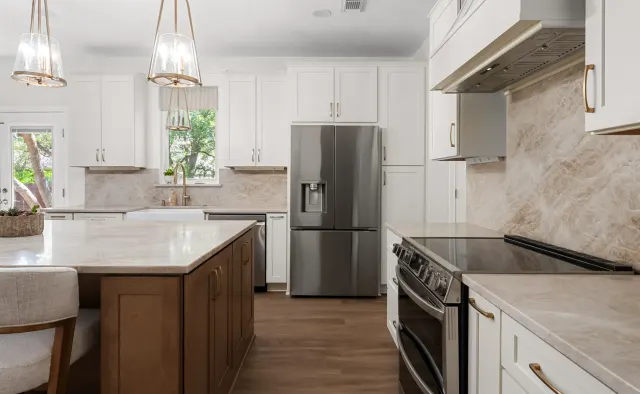 Falling Leaves Ct Residence: White perimeter + wood-stained island, large seating island, quartz counters, textured stone backsplash, open-concept — view 5